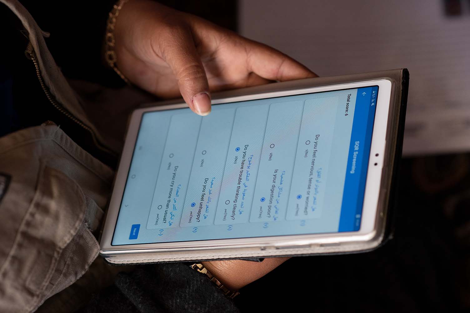 Community Health Worker using the Humanitarian Digital Health platform on a house visit